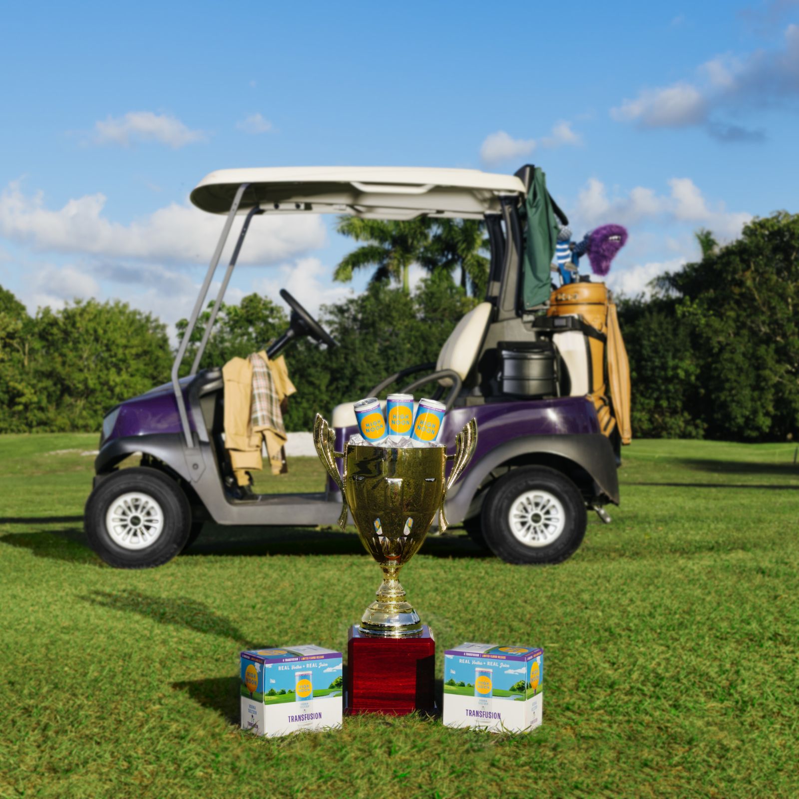 Image Golf cart with High Noon Transfusion and a trophy on a golf course
