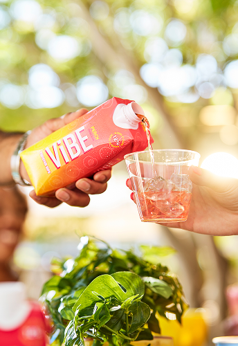 Vibe Peach being poured over ice in a glass