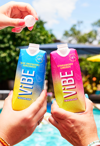 Two hands, each holding a pack of Vibe