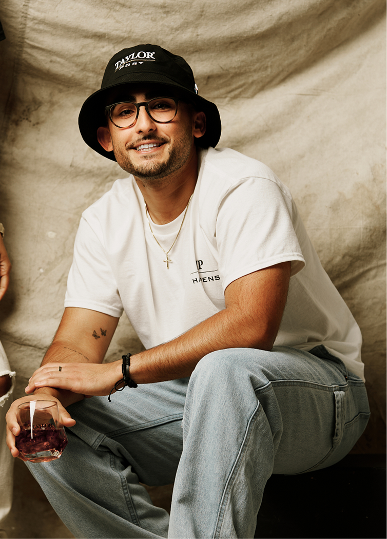 Man sitting in a pose with Taylor Port Merch on