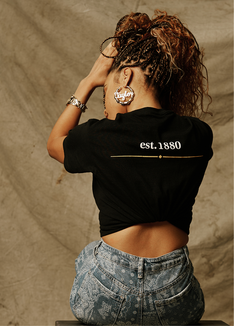 Woman wearing Tee with est. 1880 text facing backward